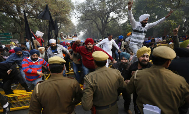 Sikhs break a barricade as they protest against Congress party Vice President Rahul Gandhi for his remark on the country's 1984 anti-Sikh riots in New Delhi on Thursday - AP Sikhs break a barricade as they protest against Congress party Vice President Rahul Gandhi for his remark on the country's 1984 anti-Sikh riots in New Delhi on Thursday - AP